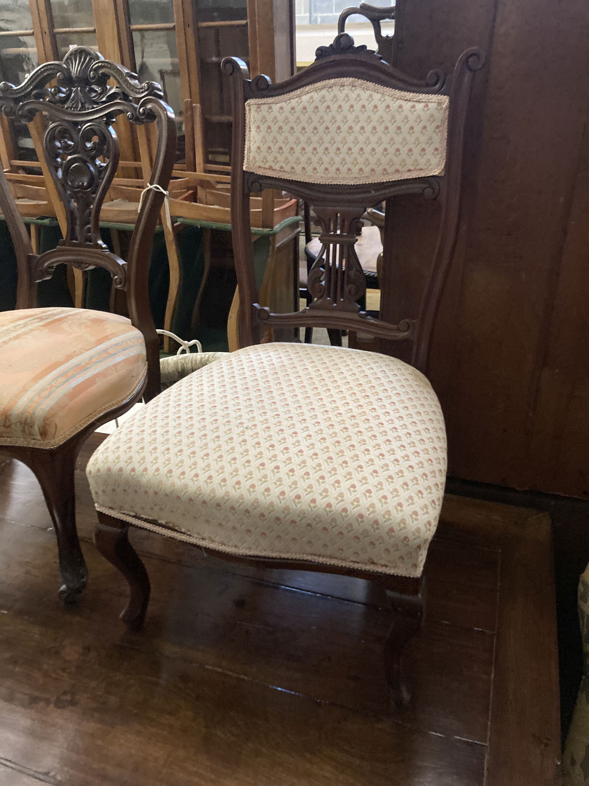 A pair of Victorian walnut dining chairs, on cabriole legs